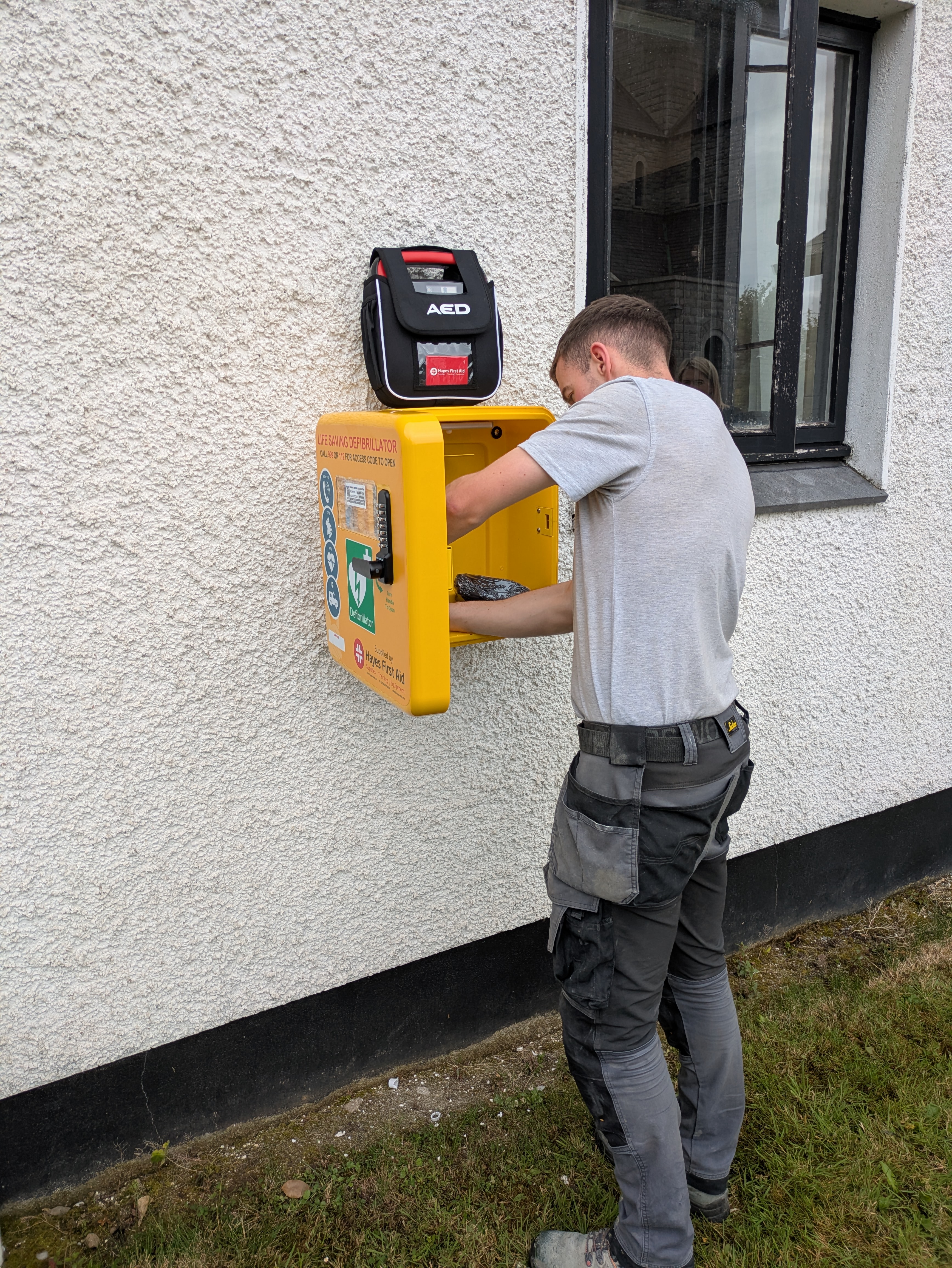 Ryan from RL Electrical  is hard at work fitting our latest defibrillator as part of our Community Fund!