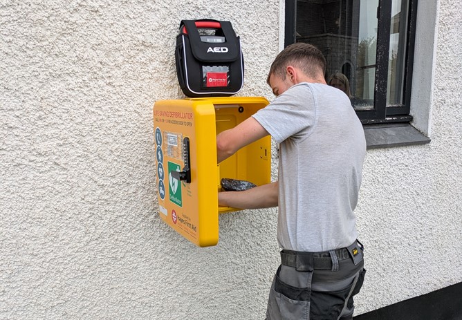 Ryan from RL Electrical is hard at work fitting our latest defibrillator as part of our Community Fund!